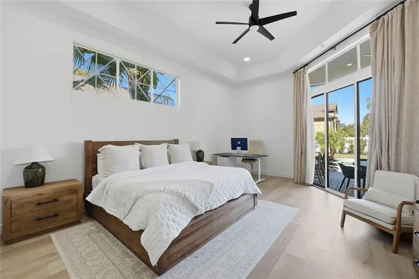 a spacious bedroom with a bed a couch and a window