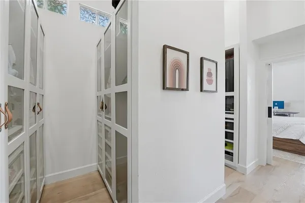 a bathroom with a double vanity sink a toilet a mirror and shower