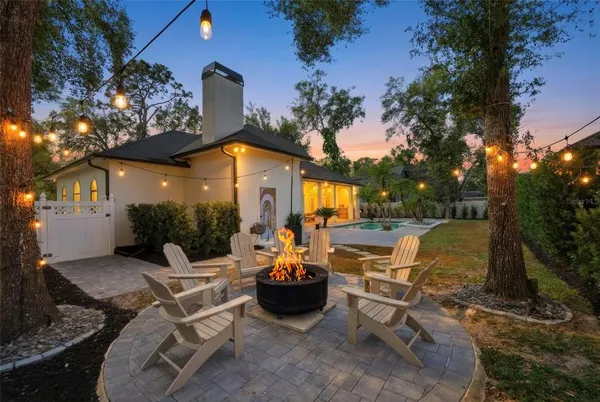 a view of a patio with table and chairs and a fire pit