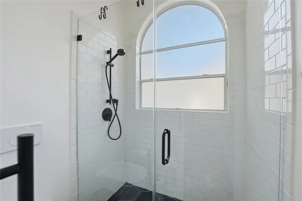 a bedroom with a bed and a chair