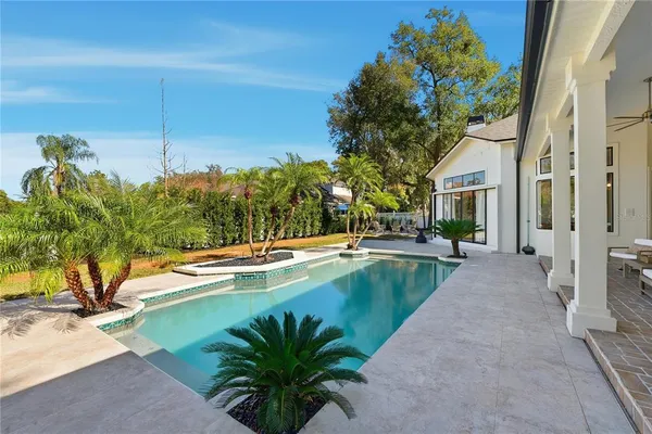 a view of swimming pool with outdoor seating and trees