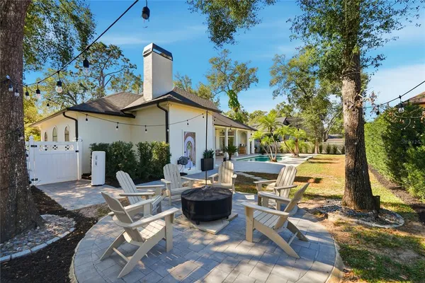 a view of a patio with table and chairs and potted plants