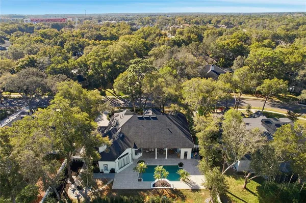 a house is sitting in middle of the garden