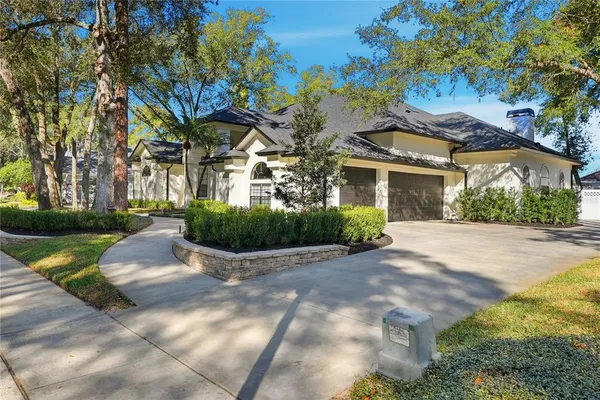 a view of house with yard and green space