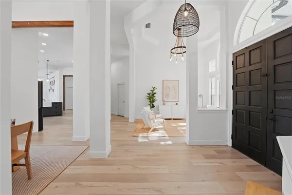 a view of empty room with wooden floor and window