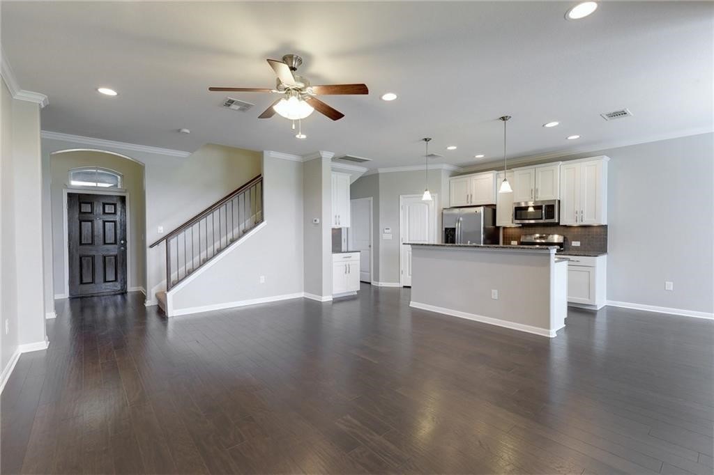 13400 Briarwick Drive, Unit 2502 Austin, TX 78729 - Photo 1 of 20 a view of kitchen with cabinets wooden floor and stainless steel appliances