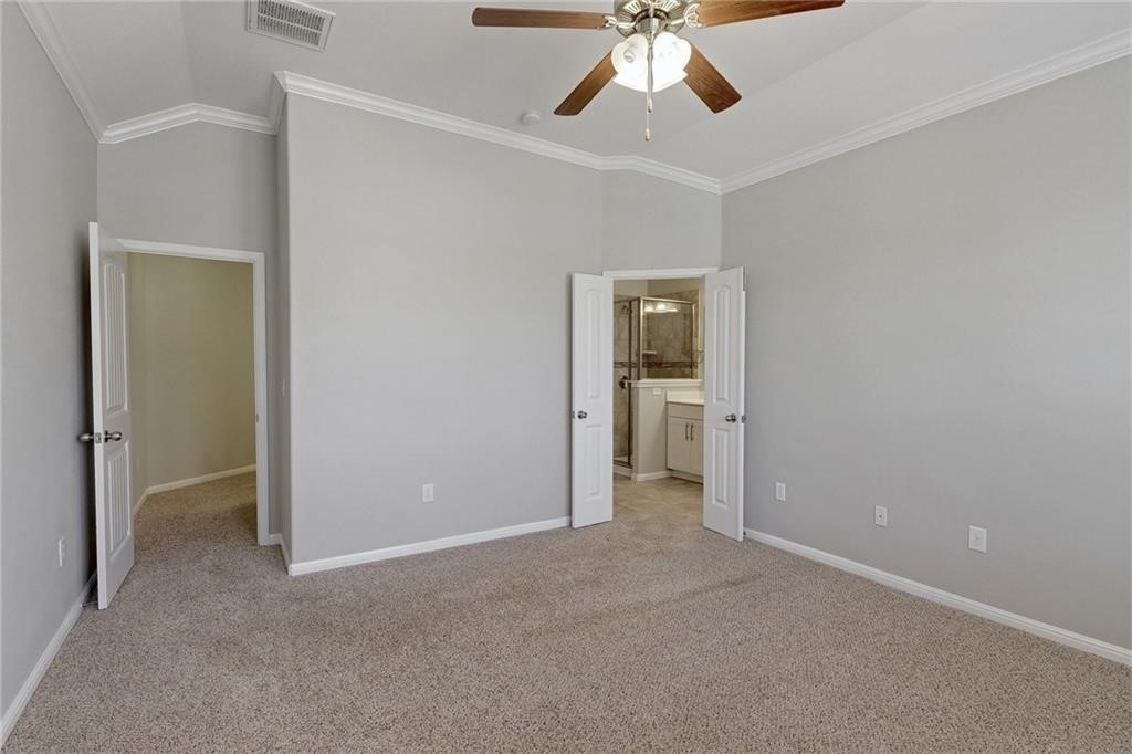 13400 Briarwick Drive, Unit 2502 Austin, TX 78729 - Photo 13 of 20 an empty room and chandelier fan in a room