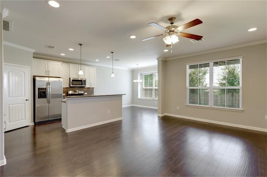 13400 Briarwick Drive, Unit 2502 Austin, TX 78729 - Photo 5 of 20 a view of kitchen with refrigerator stove and wooden floor