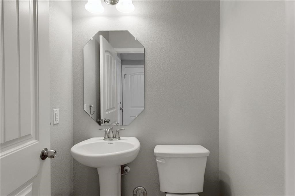 13400 Briarwick Drive, Unit 2502 Austin, TX 78729 - Photo 7 of 20 a bathroom with a toilet sink and mirror