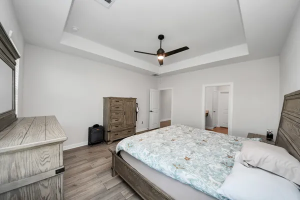 a bedroom with a bed and a dresser in it