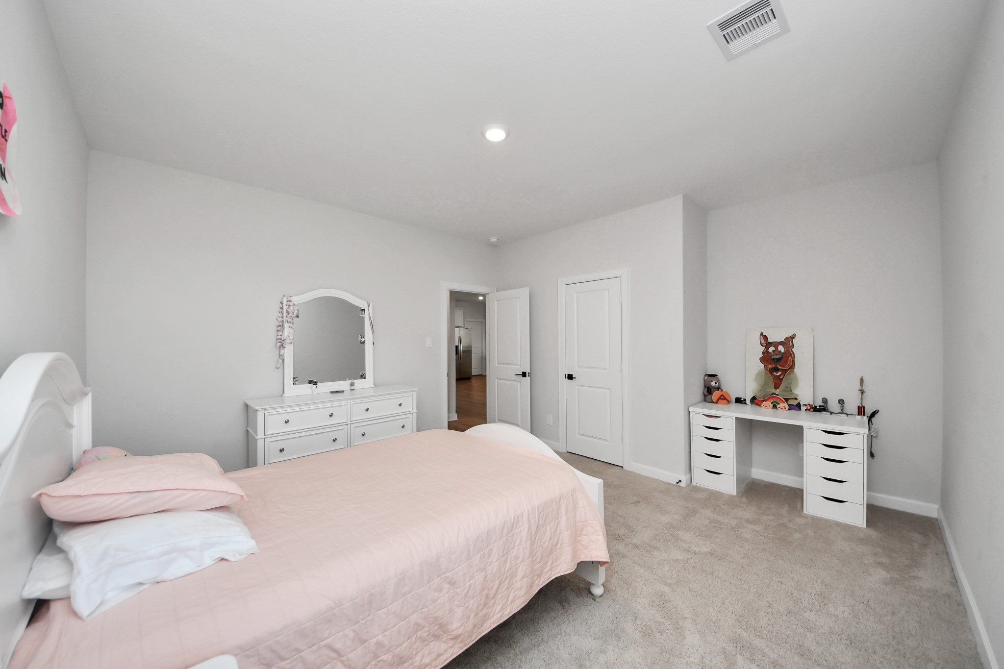 3006 Floating Barque Drive Santa Fe, TX 77510 - Photo 23 of 37 This is a bright, cozy 2nd bedroom fits a twin or full bed comfortably. The room has neutral walls and carpet, offering a clean and inviting space.