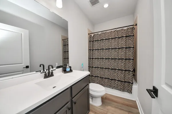 a bathroom with a sink toilet and shower