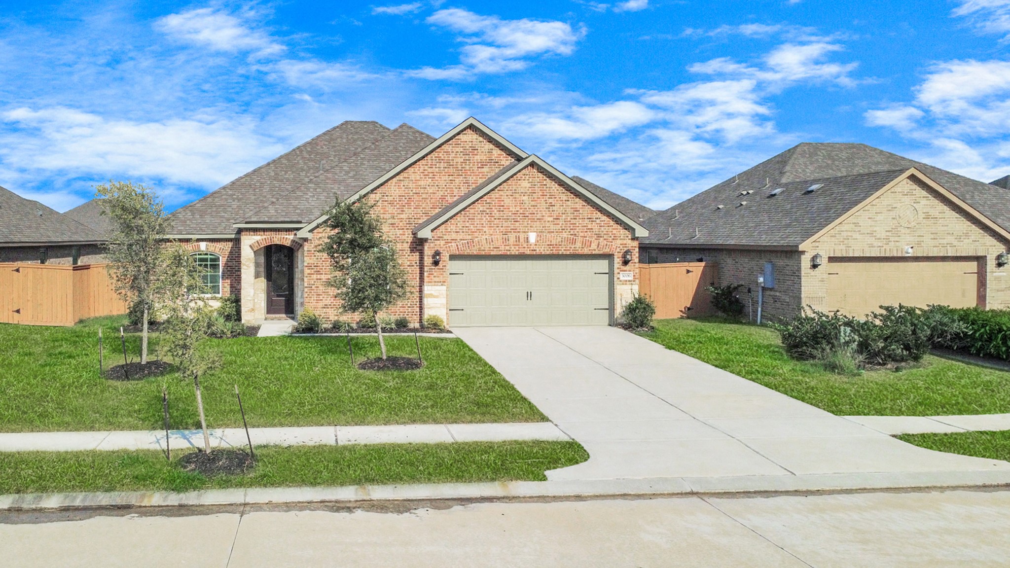3006 Floating Barque Drive Santa Fe, TX 77510 - Photo 3 of 37 charming single-story brick home with a well-maintained front yard, a two-car garage, and a welcoming entrance.