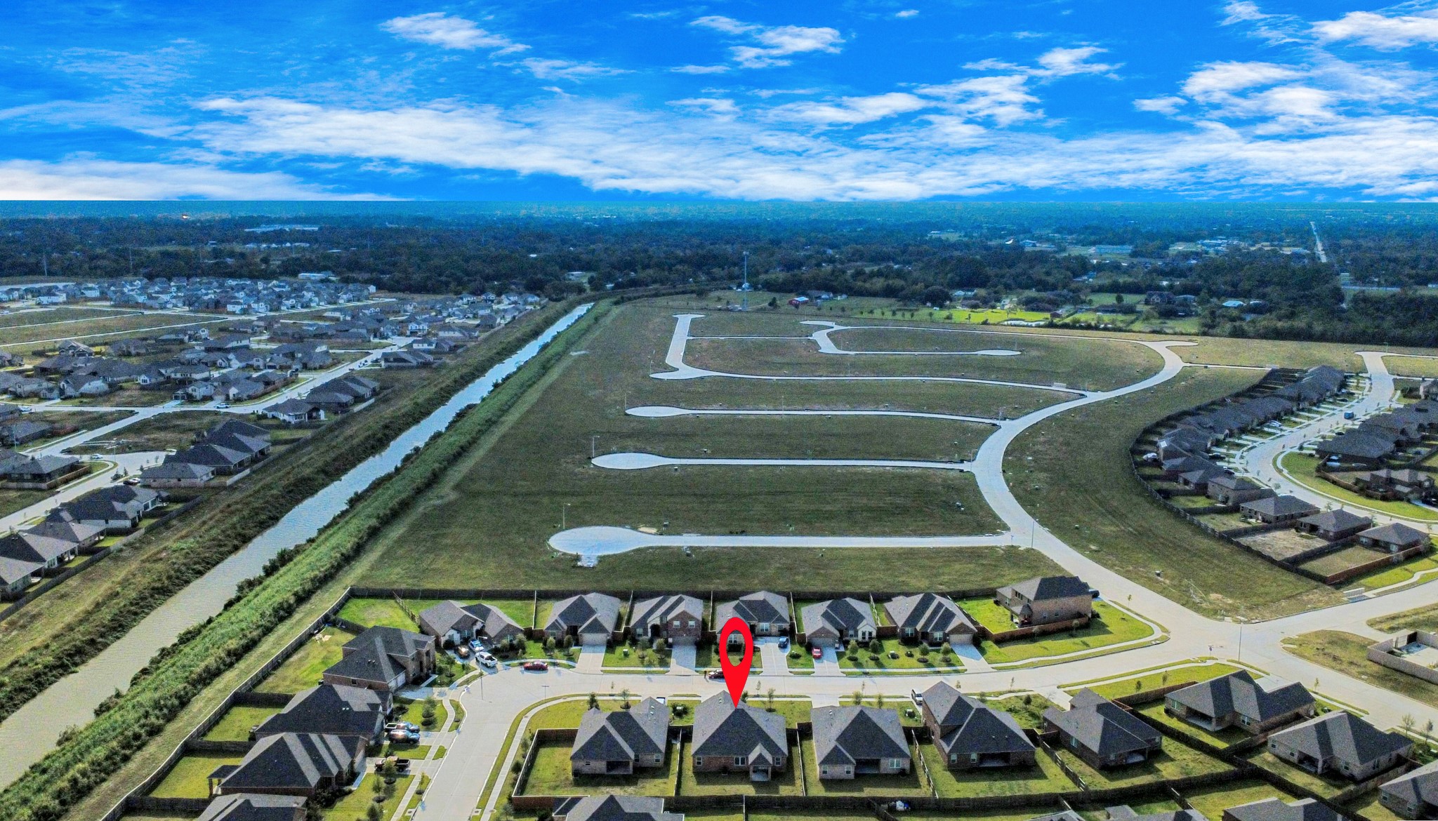 3006 Floating Barque Drive Santa Fe, TX 77510 - Photo 31 of 37 This aerial photo shows a suburban neighborhood with neatly arranged homes and a highlighted property. The area features well-maintained roads and open green spaces, offering a peaceful and spacious environment.