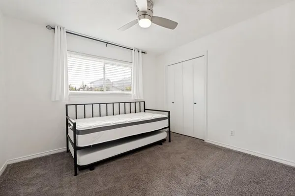 a view of a room with a window and a ceiling fan
