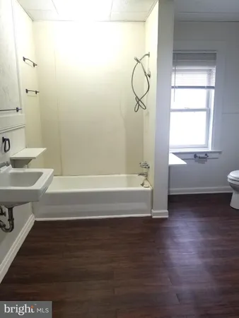 a bathroom with a sink a mirror and a bathtub