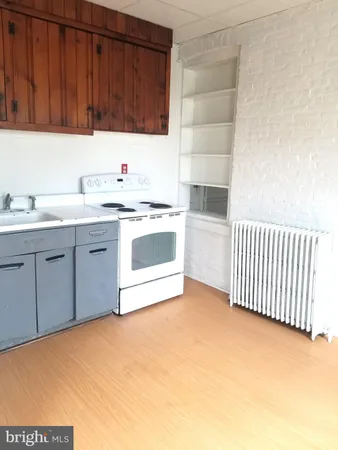 a kitchen with a sink cabinets and appliances