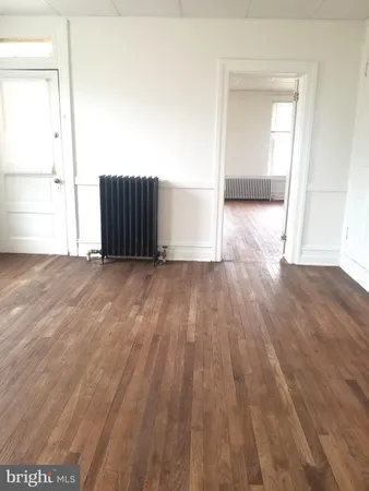 an empty room with wooden floor