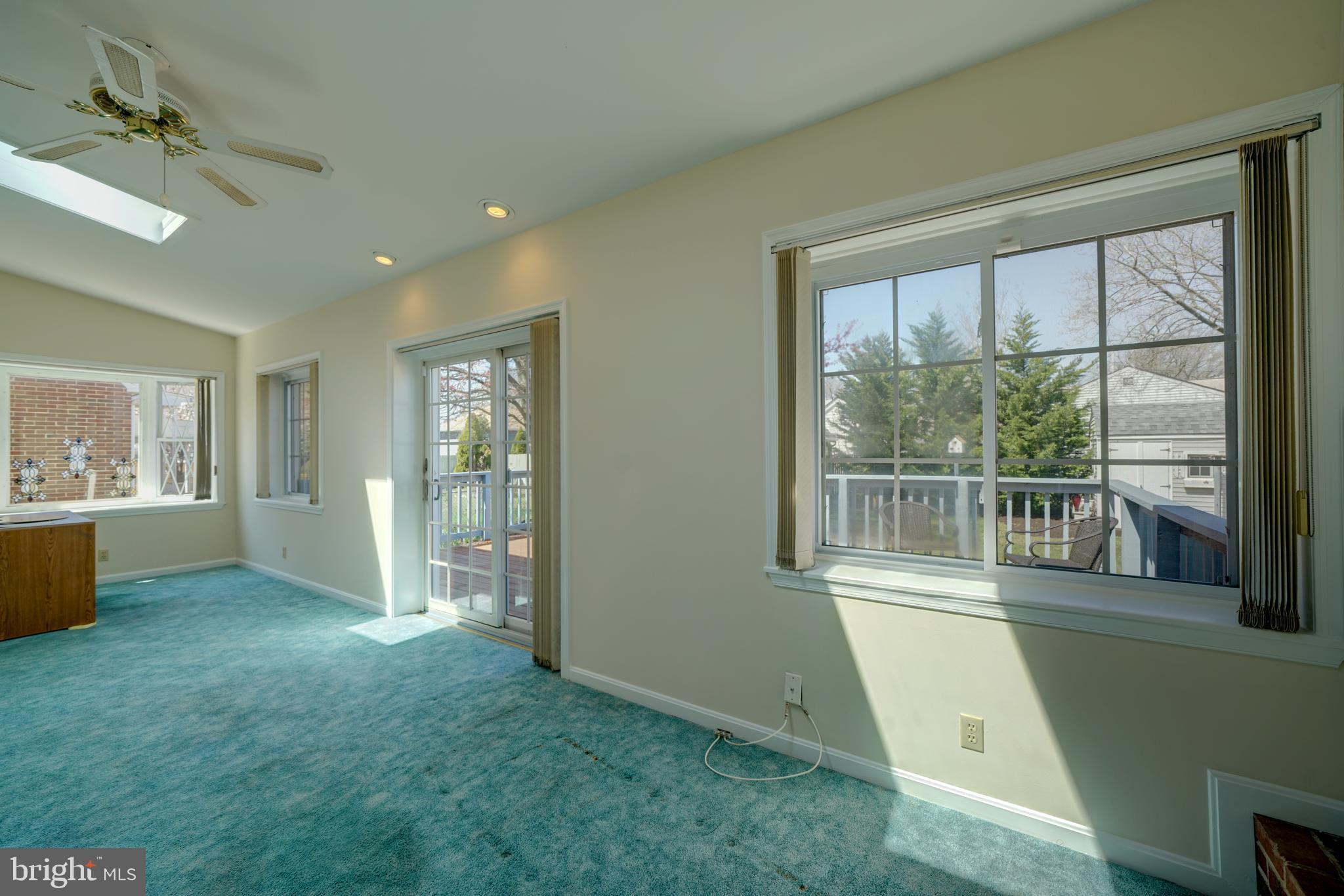 242 Carroll Road Pasadena, MD 21122 - Photo 24 of 39 Main level family room opens to large deck