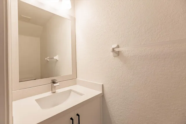 a bathroom with a sink double vanity and a mirror