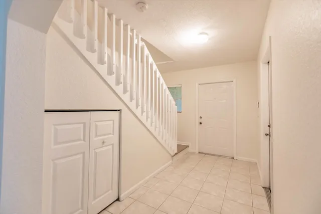 a large kitchen with a sink and refrigerator