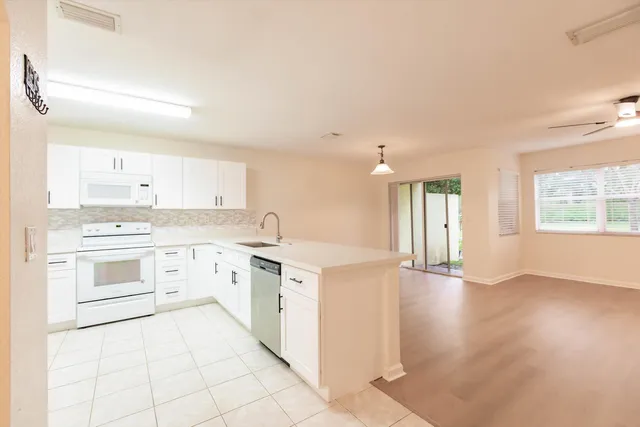 a large kitchen with a lot of counter space and a sink