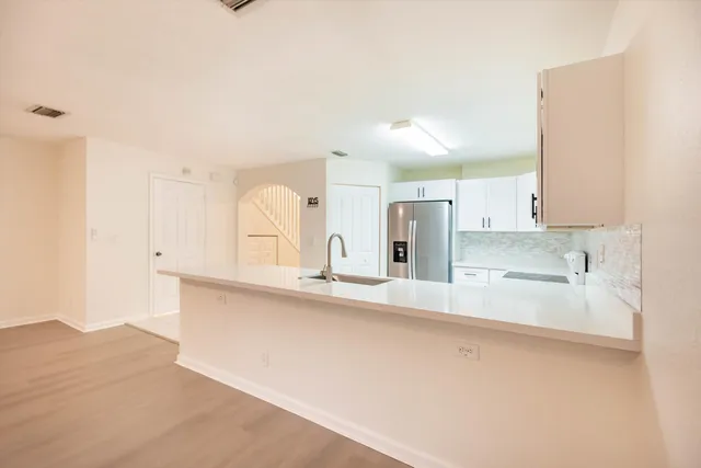 a spacious bathroom with a double vanity sink a mirror and a bathtub