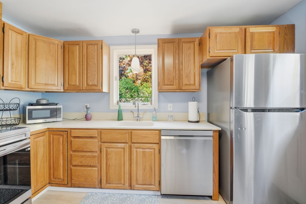 28 Collingwood Road Springfield, MA 01119 - Photo 11 of 32 a kitchen with a refrigerator sink and cabinets