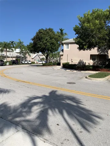 a view of road with card parked on side and road