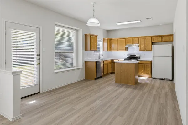 a view of kitchen with granite countertop cabinets and wooden floor