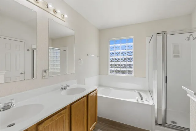 a bathroom with a tub sink and mirror
