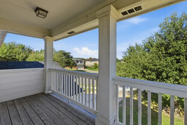 a view of balcony with wooden floor