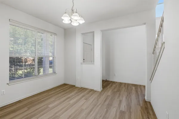 a view of kitchen with granite countertop cabinets and wooden floor