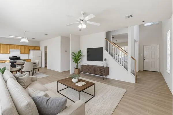 a living room with furniture and a wooden floor