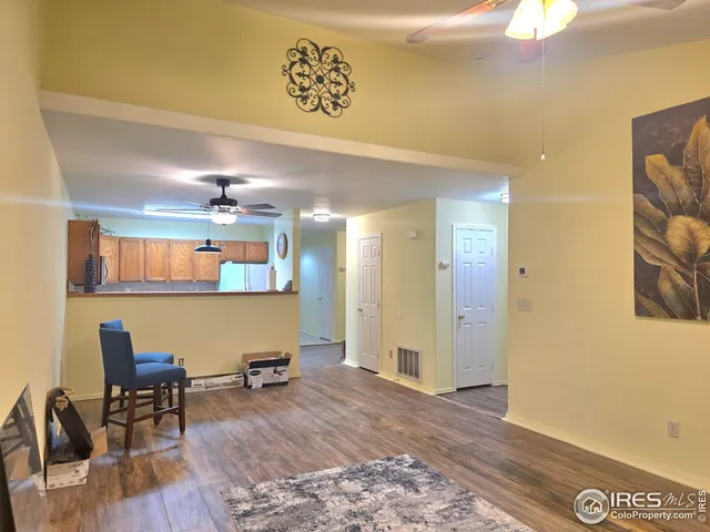 a view of a room with furniture and wooden floor