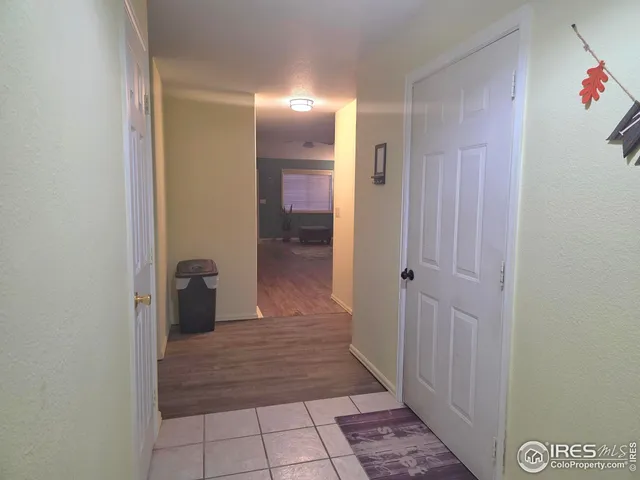 a view of a hallway with wooden shelves