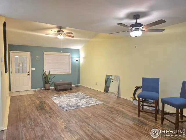a view of a livingroom with furniture and chandelier fan