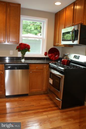 9314 Sudbury Road Silver Spring, MD 20901 - Photo 2 of 30 a kitchen with stainless steel appliances a stove a microwave and sink