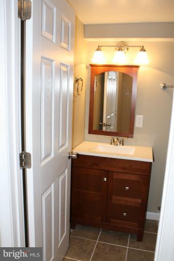 9314 Sudbury Road Silver Spring, MD 20901 - Photo 13 of 30 a bathroom with a sink and a mirror