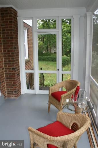9314 Sudbury Road Silver Spring, MD 20901 - Photo 3 of 30 a balcony with furniture and wooden floor