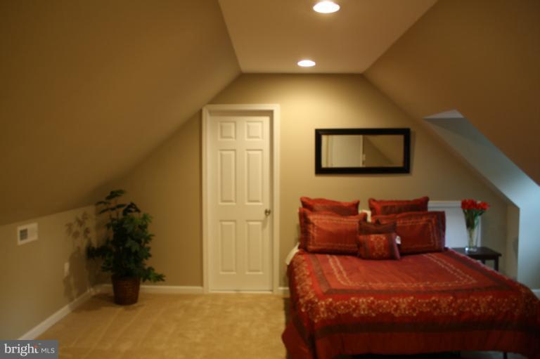 9314 Sudbury Road Silver Spring, MD 20901 - Photo 21 of 30 a bedroom with a bed and a walk in closet