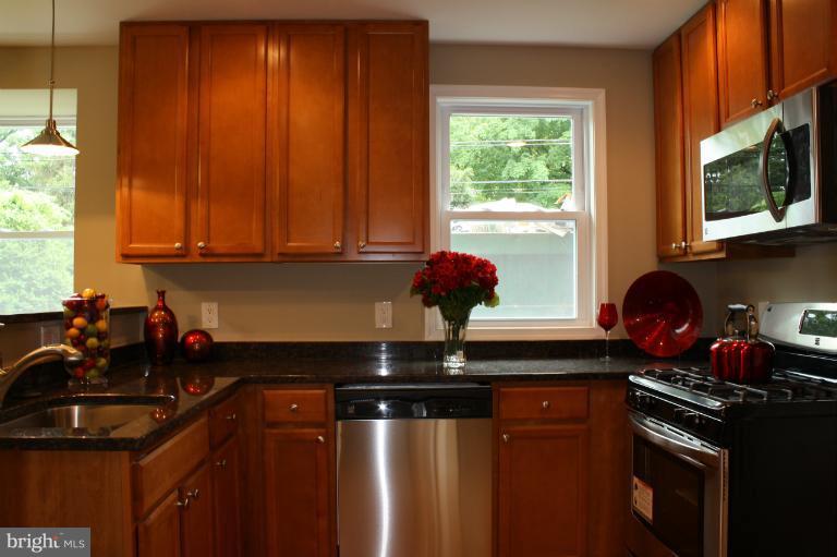 9314 Sudbury Road Silver Spring, MD 20901 - Photo 23 of 30 a kitchen with a sink a stove and a window