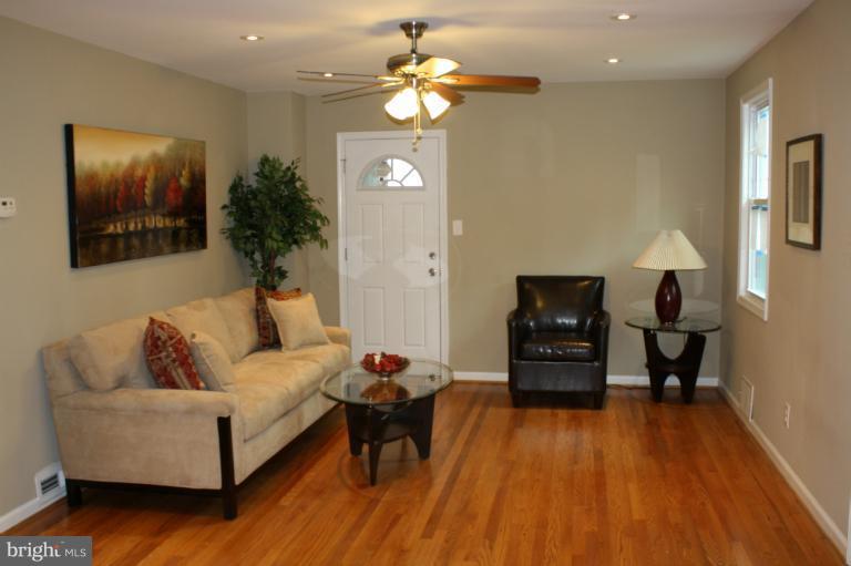 9314 Sudbury Road Silver Spring, MD 20901 - Photo 24 of 30 a living room with furniture and a chandelier