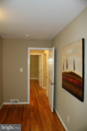 9314 Sudbury Road Silver Spring, MD 20901 - Photo 28 of 30 a view of a room with wooden floor and bathroom