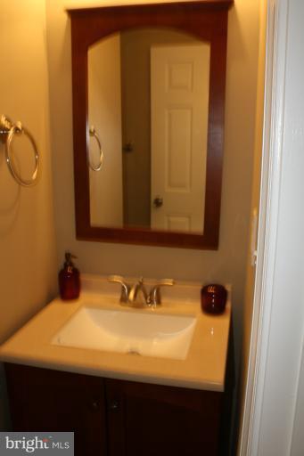 9314 Sudbury Road Silver Spring, MD 20901 - Photo 29 of 30 a bathroom with a sink and a mirror