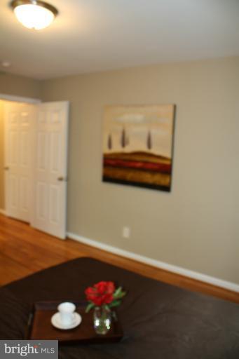 9314 Sudbury Road Silver Spring, MD 20901 - Photo 4 of 30 a view of a room with wooden floor and cabinets