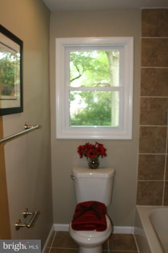 9314 Sudbury Road Silver Spring, MD 20901 - Photo 5 of 30 a bathroom with a toilet and a window
