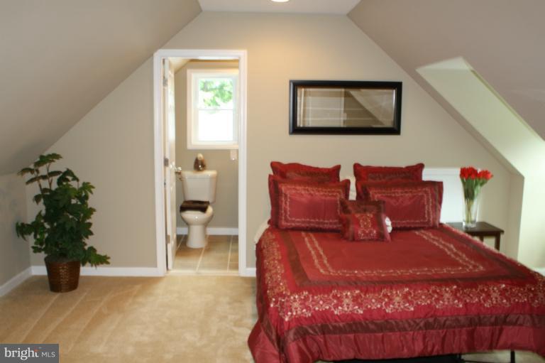 9314 Sudbury Road Silver Spring, MD 20901 - Photo 6 of 30 a large bed sitting in a bedroom next to a window