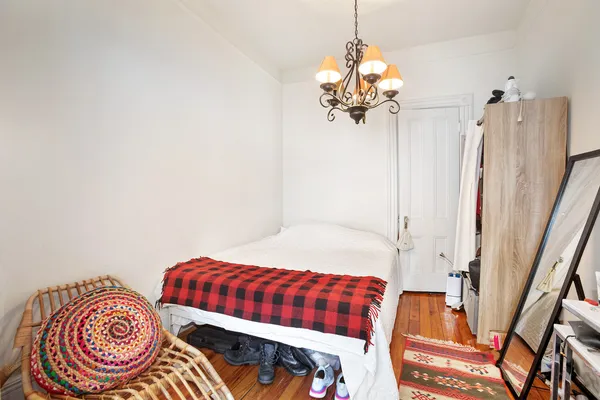 a bedroom with a bed and a chandelier