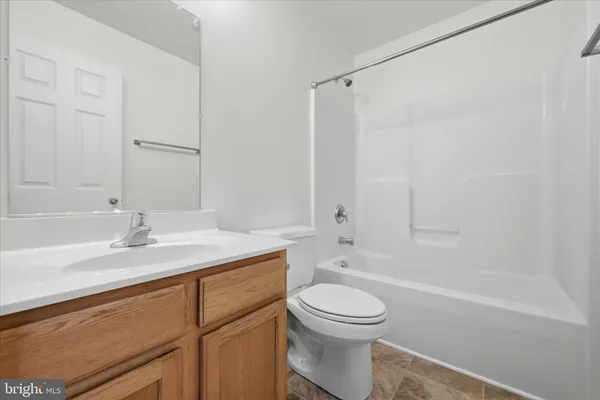 a bathroom with a granite countertop sink a toilet and shower
